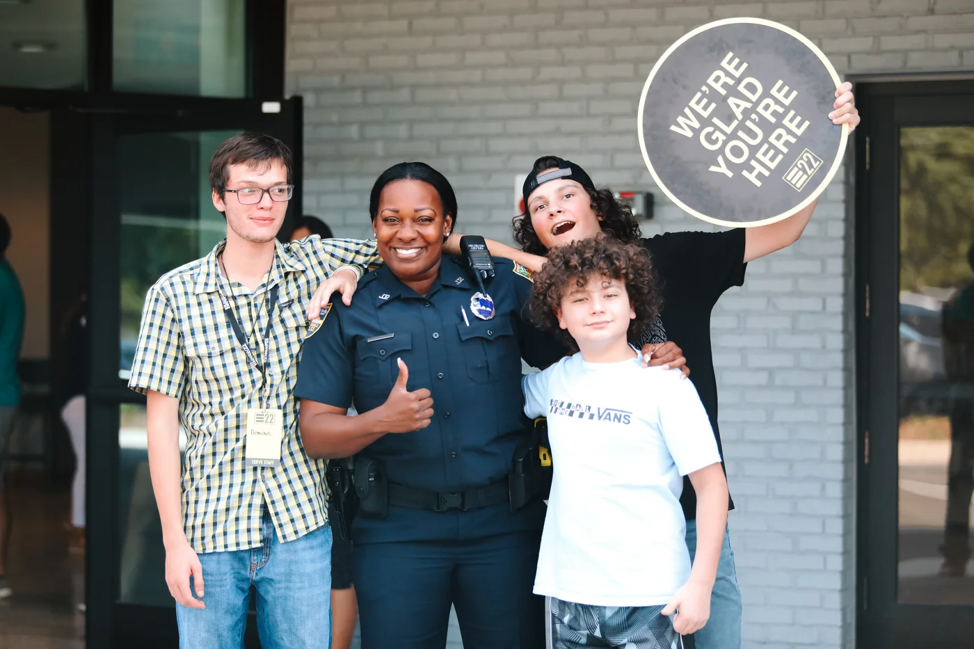 A uniformed first responder with three people outside a church entrance