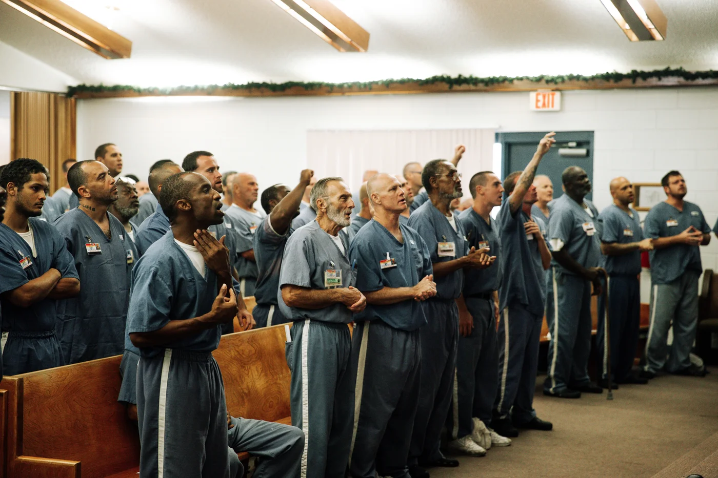 Men worshiping together in a prison chapel