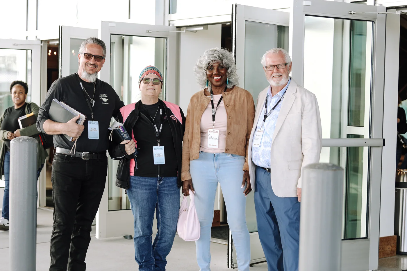 Four adults smiling together at a church entrance
